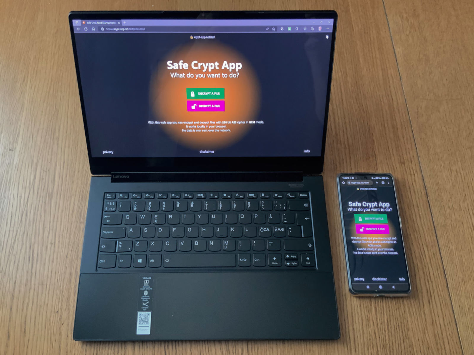 A laptop and a phone showing Safe Crypt App